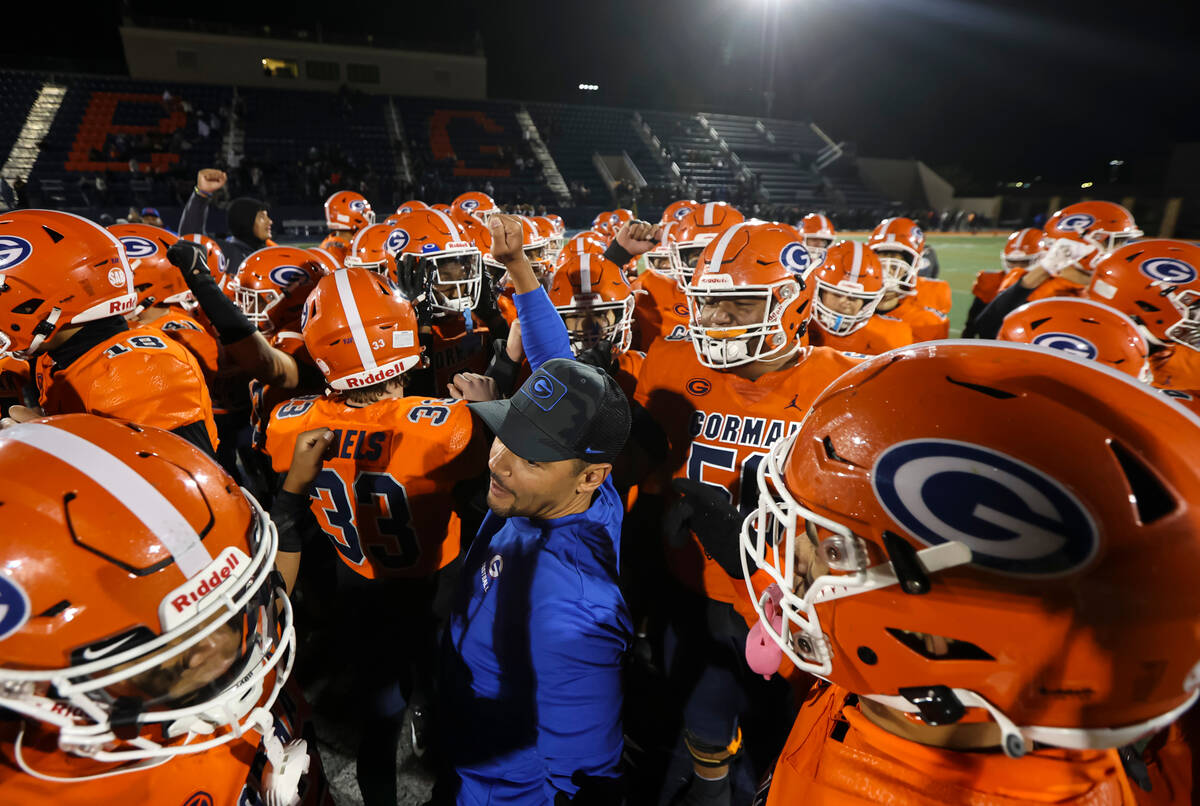 Bishop Gorman head coach Brent Browner huddles with players after defeating Desert Pines in a C ...