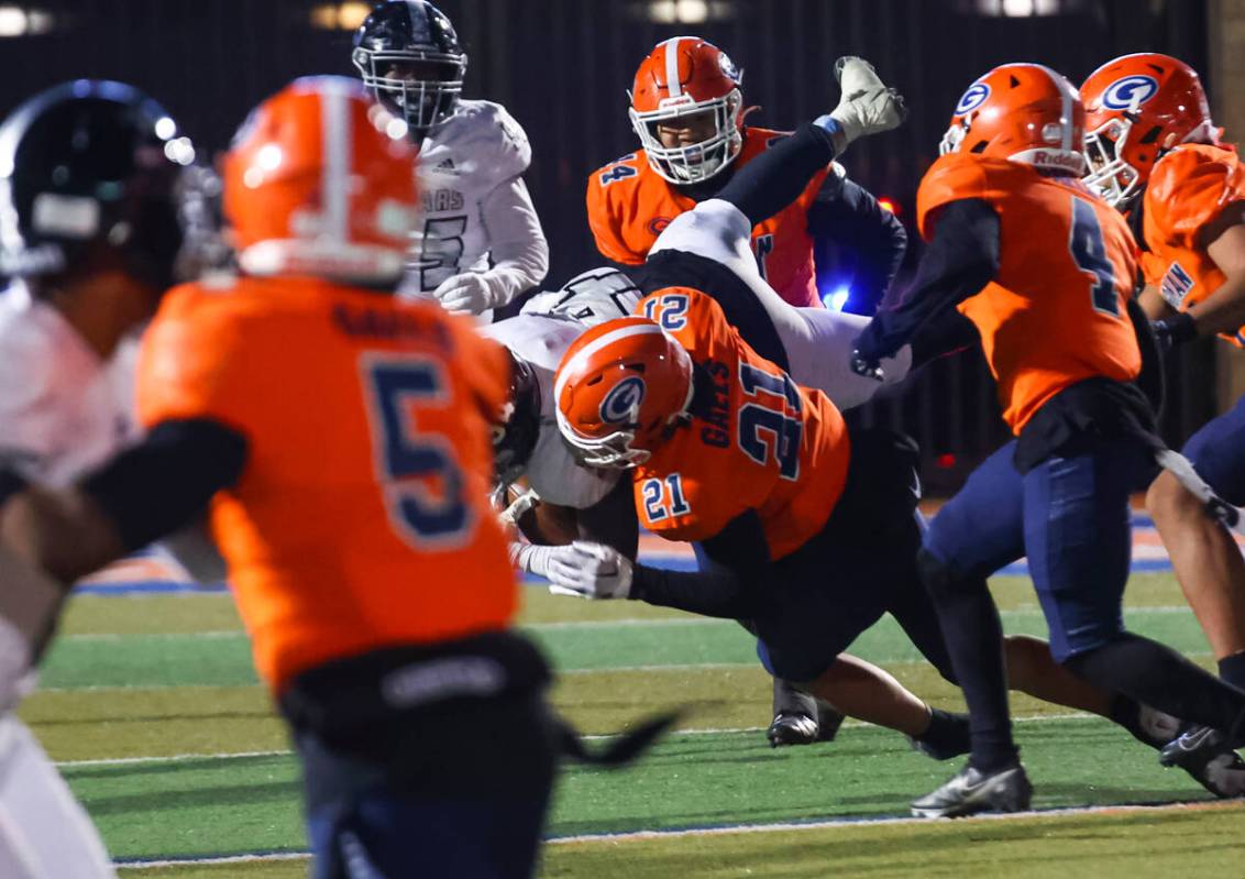 Bishop Gorman’s Charles Correa (21) tackles Desert Pines’ Malik Jones (34) during ...