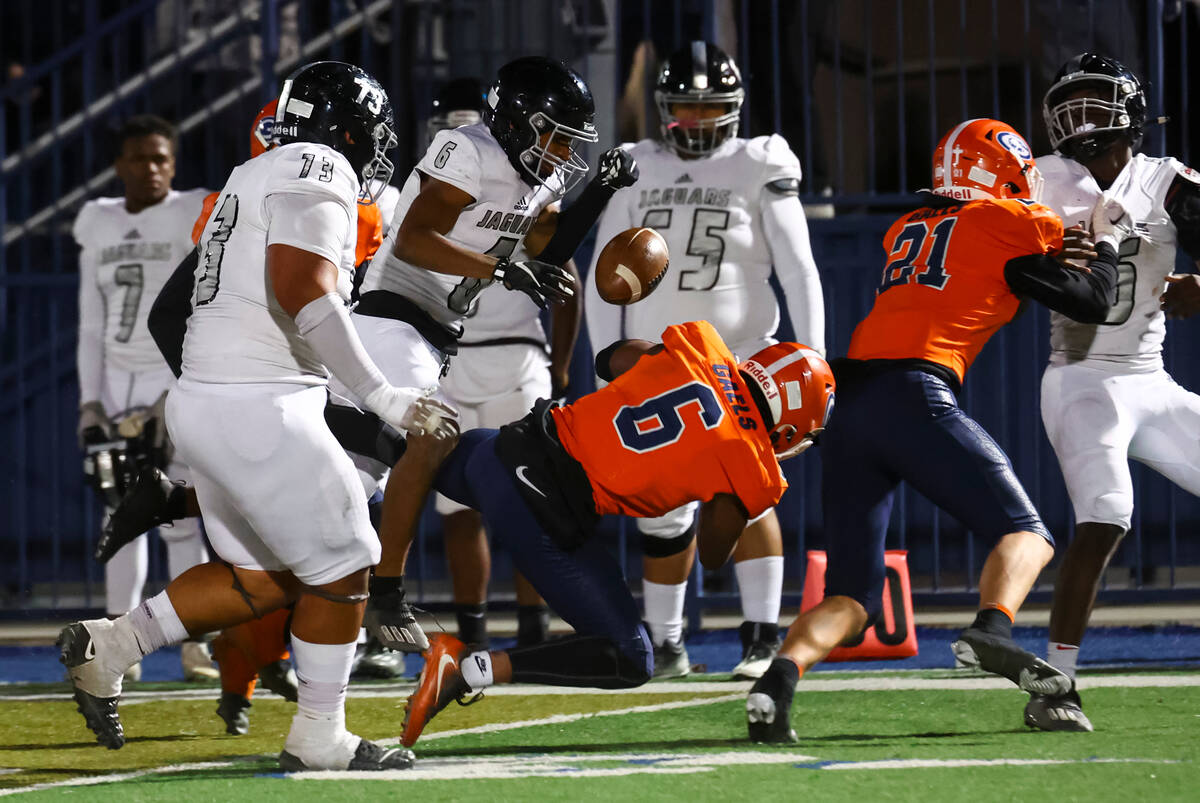 Bishop Gorman’s Jeremiah Hughes (6) fumbles the ball after running on an interception ag ...