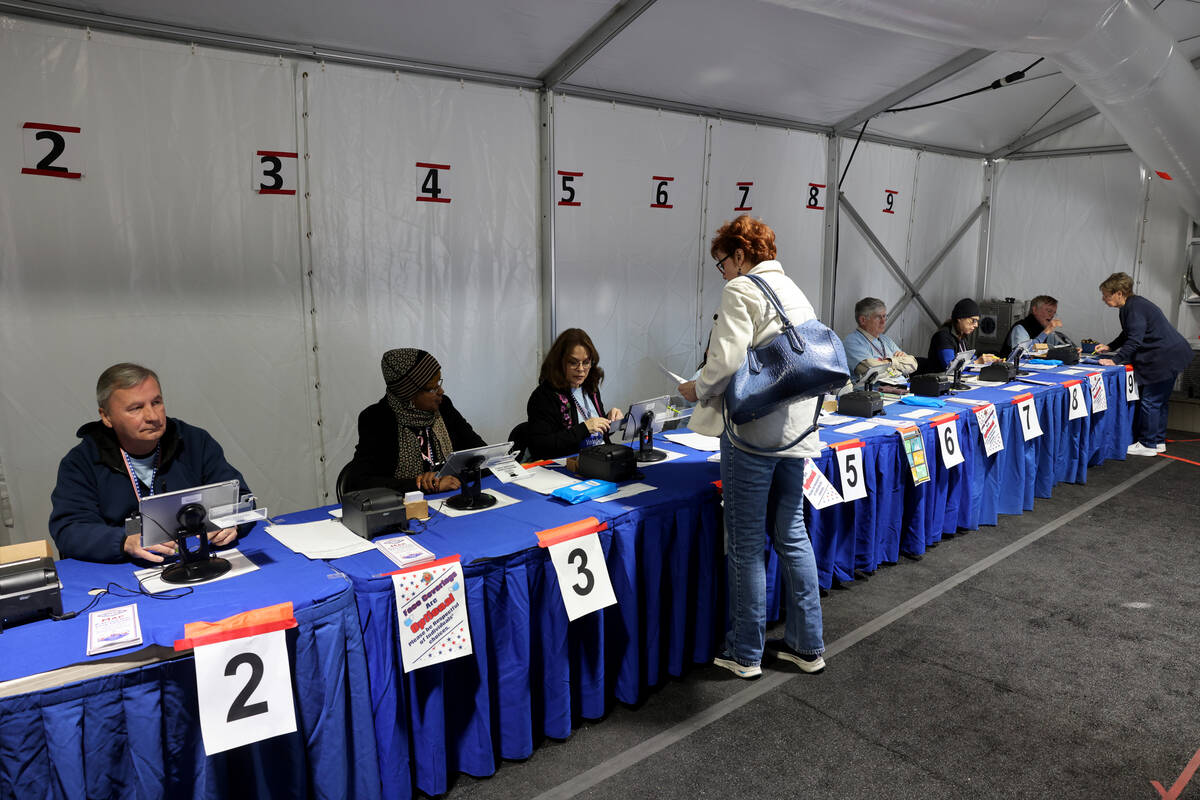 Voters check in before casting their ballots in an event tent at Arroyo Market Square on the la ...