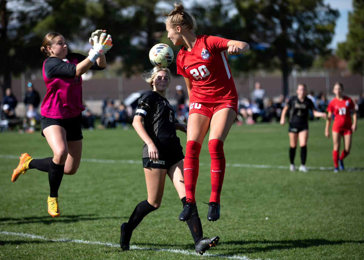 Coronado’s Cate Gusick (20) attempts to head the ball for a goal while Faith Lutheran&# ...