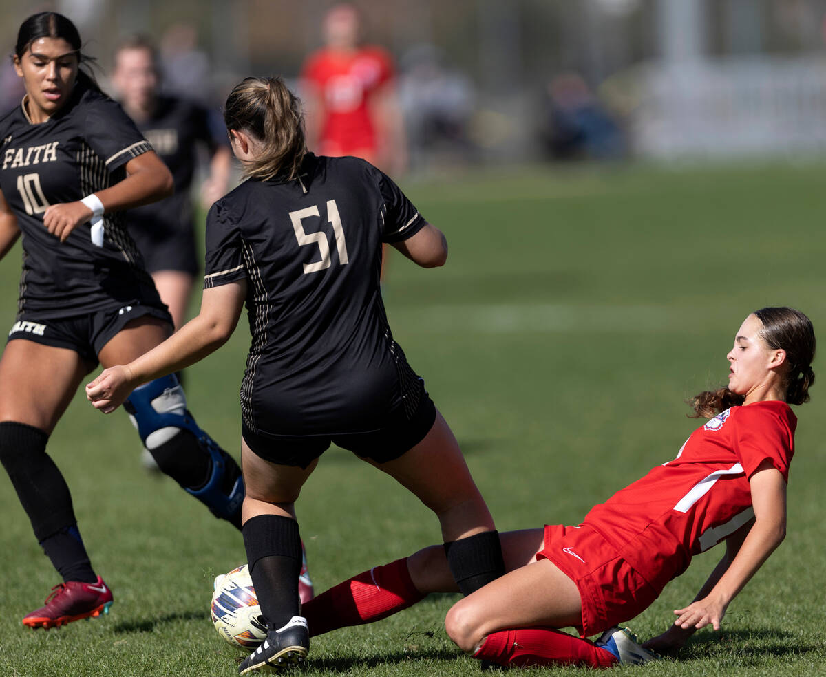 Coronado’s Trinity Buchanan, right, slide tackles Faith Lutheran’s Lana Linares ( ...
