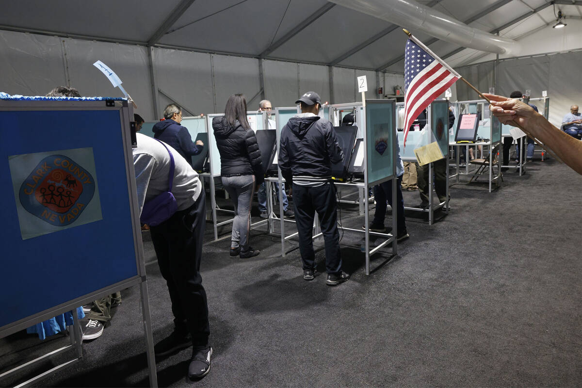 People prepare to vote at Silverado Ranch Plaza, an early voting location, Friday, Nov. 4, 2022 ...