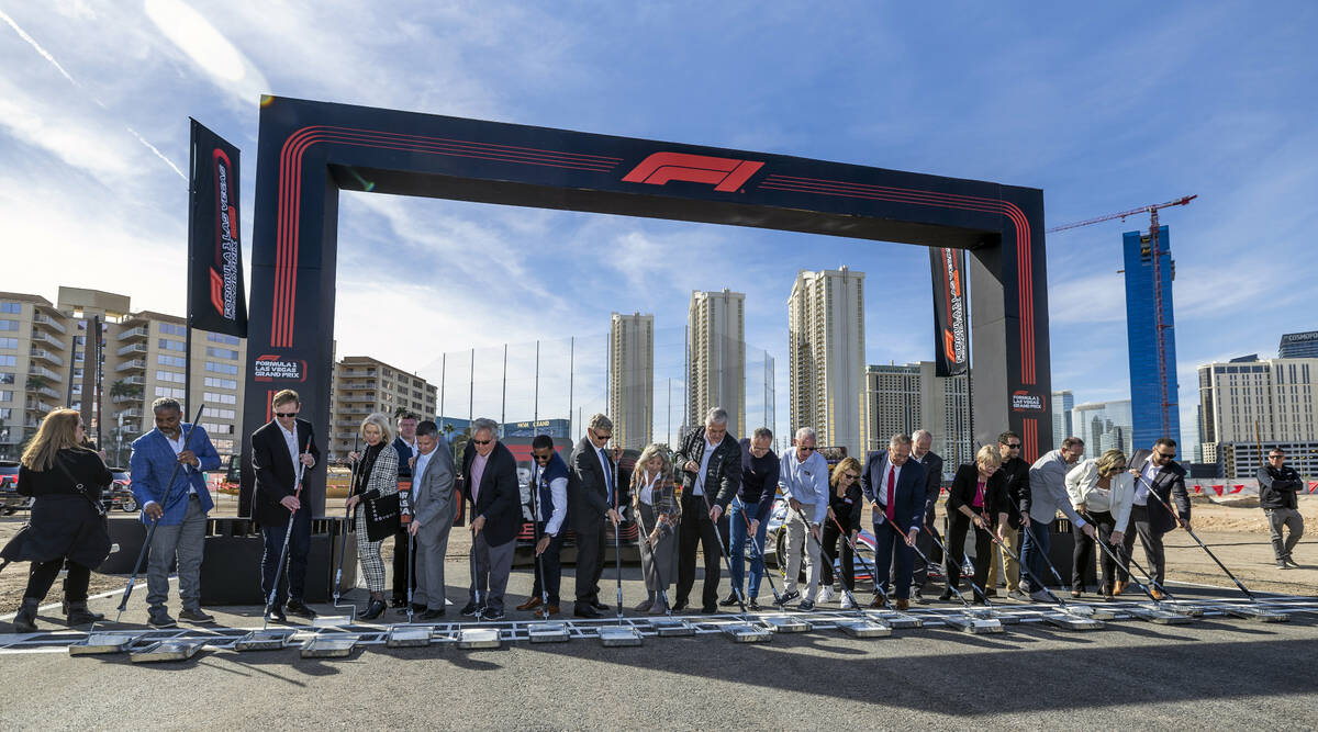 Formula One Las Vegas Grand Prix dignitaries and guests push rollers during a start/finish line ...