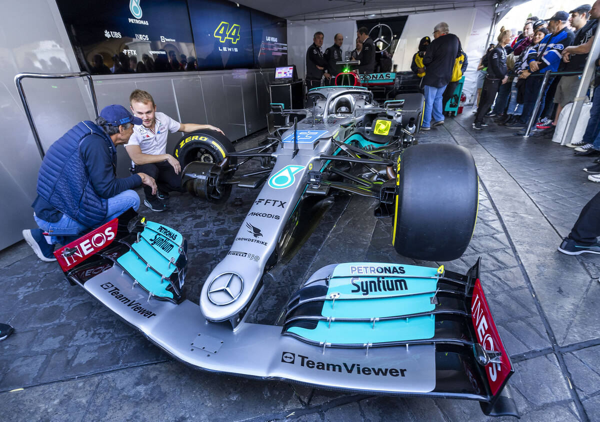 A team technician shows off the Lewis Hamilton – Mercedes-AMG Petronas racing car during ...