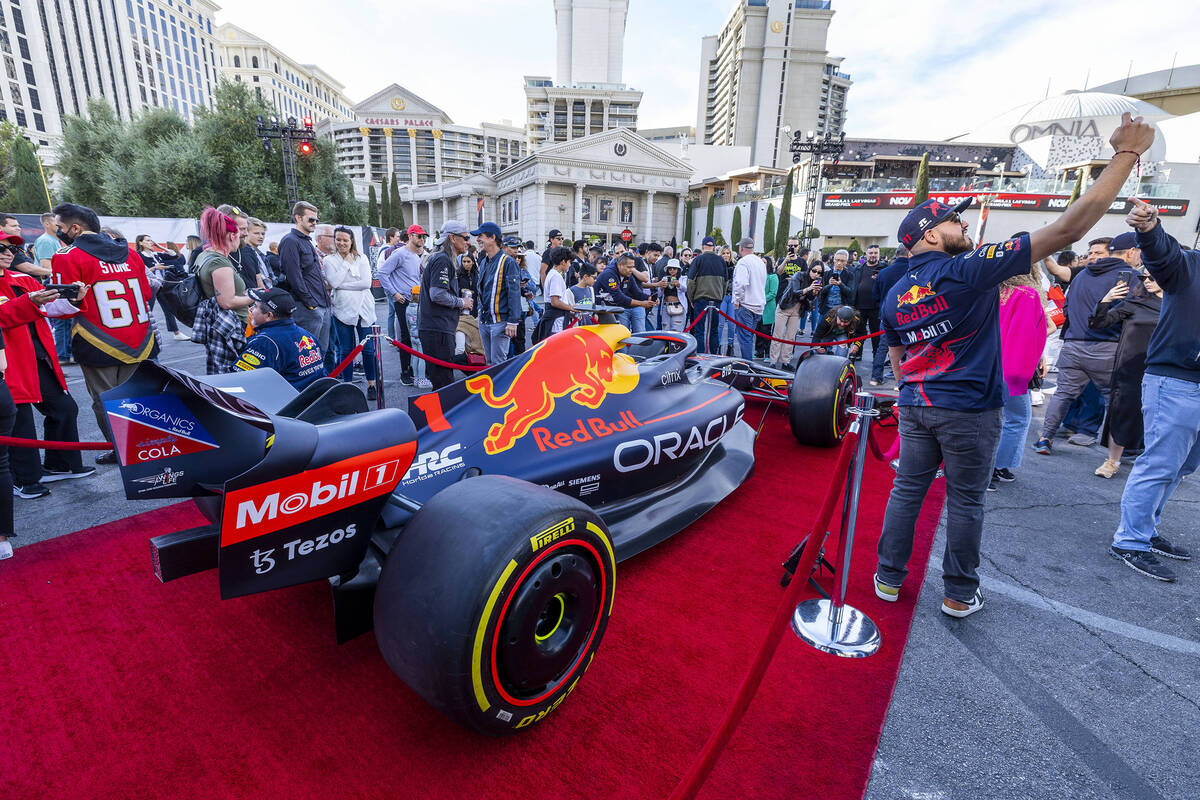 Fans check out a Red Bull race car during the Formula One Las Vegas Grand Prix Fan Fest at Caes ...