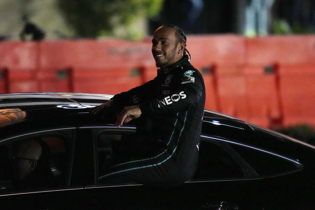 Lewis Hamilton waves from a car at a launch party for the Formula One Las Vegas Grand Prix, Sat ...