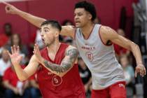 UNLV Rebels guard Jordan McCabe (5) anticipates a pass while center David Muoka (12) signals to ...