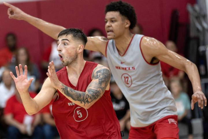 UNLV Rebels guard Jordan McCabe (5) anticipates a pass while center David Muoka (12) signals to ...