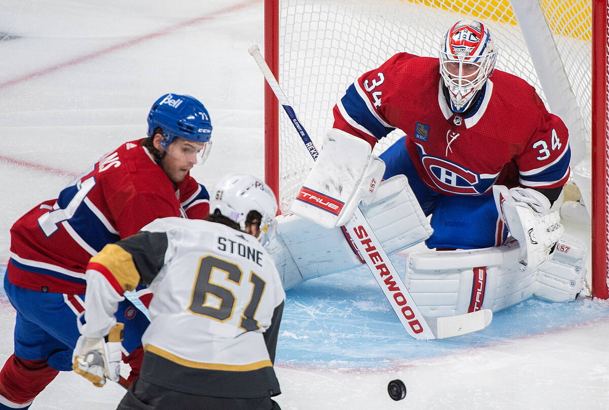 Montreal Canadiens goaltender Jake Allen watches as Vegas Golden Knights' Mark Stone (61) and C ...