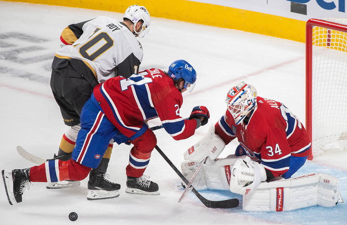 Vegas Golden Knights' Nicolas Roy (10) moves in on Montreal Canadiens goaltender Jake Allen as ...