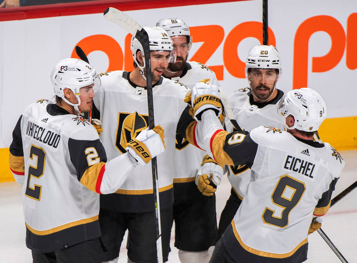 Vegas Golden Knights' Nicolas Hague (14) celebrates with teammates after scoring against the Mo ...