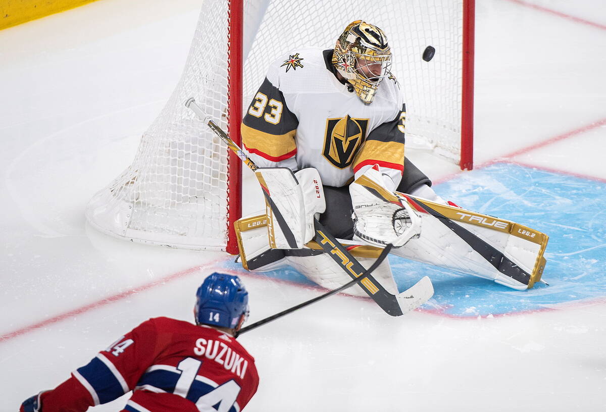 Montreal Canadiens' Nick Suzuki (14) scores against Vegas Golden Knights goaltender Adin Hill d ...