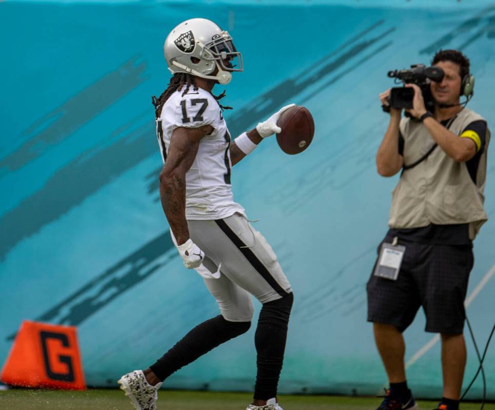 Raiders wide receiver Davante Adams (17) scores a touchdown during the first half of an NFL gam ...