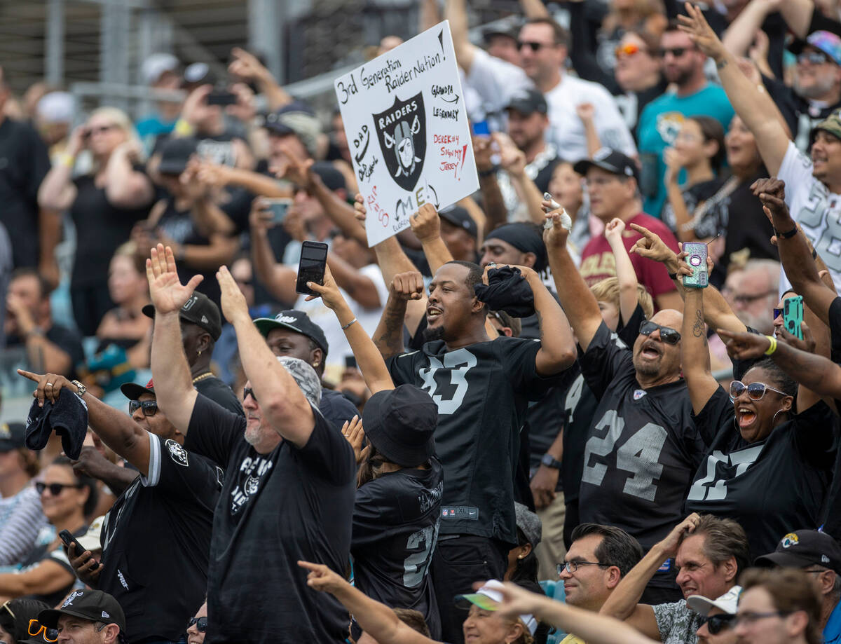 Raiders fans celebrate Raiders wide receiver Davante Adams’ ouchdown score, not pictured ...