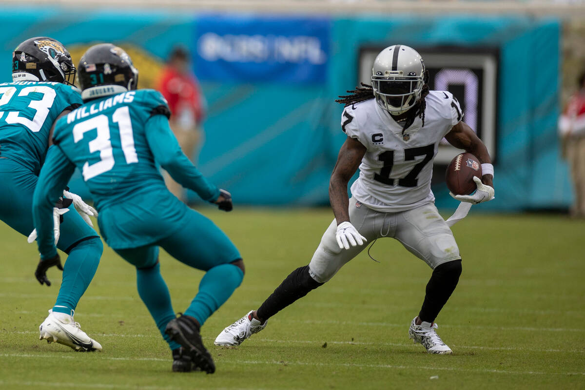 Raiders wide receiver Davante Adams (17) makes a catch and looks to run past Jacksonville Jagua ...