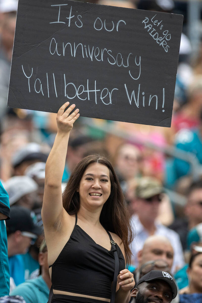 A Raiders fan holds up a sign during the first half of an NFL game against the Jacksonville Jag ...