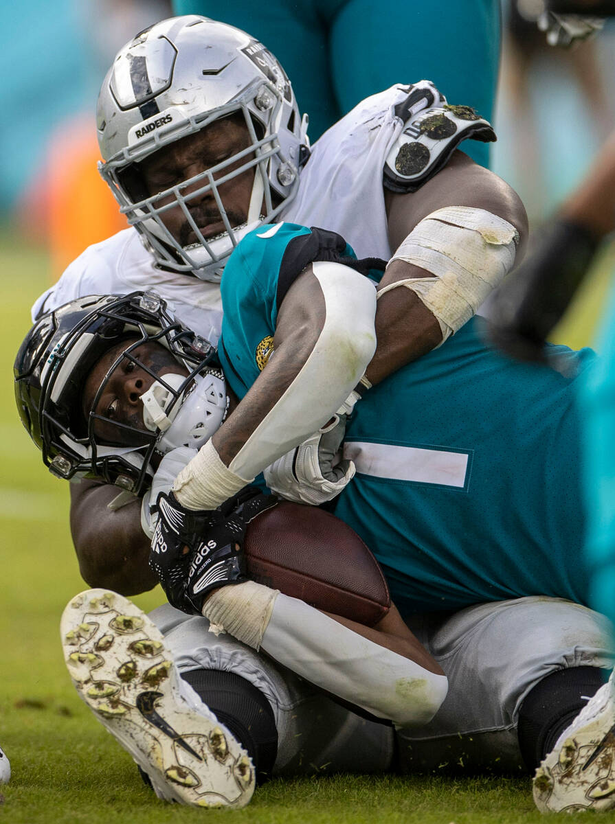 Raiders defensive tackle Andrew Billings (97) tackles Jacksonville Jaguars running back Travis ...