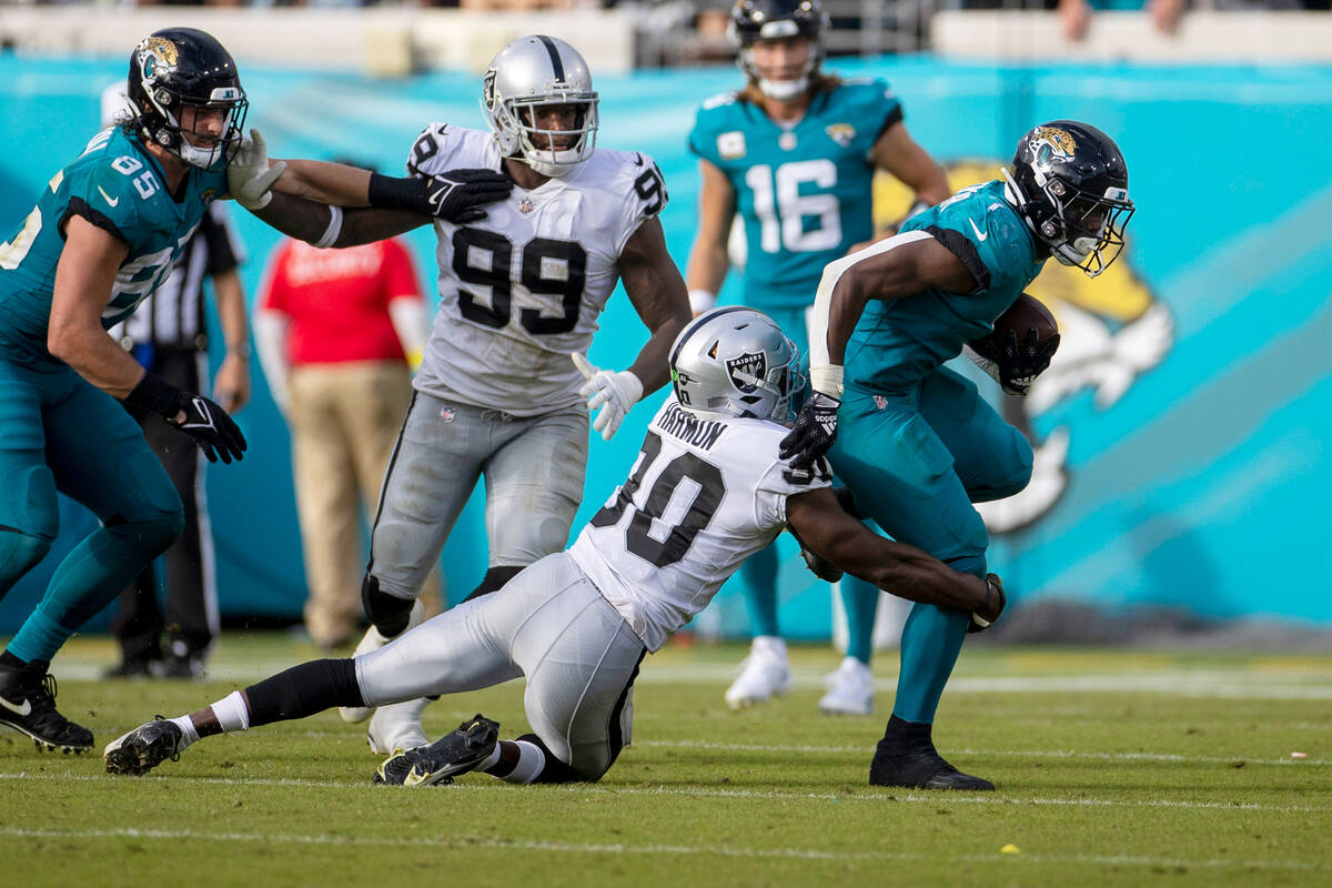 Raiders safety Duron Harmon (30) can’t bring down Jacksonville Jaguars running back Trav ...