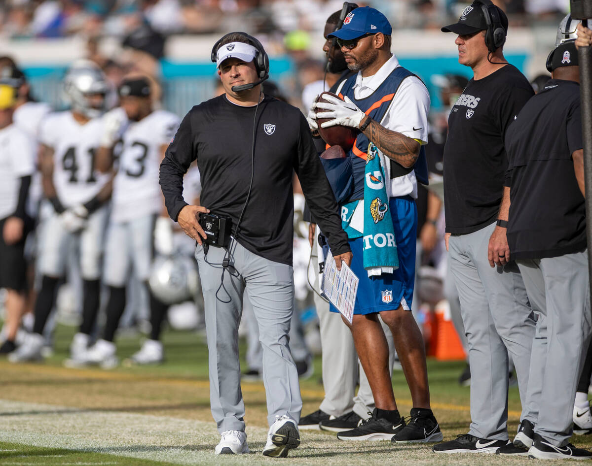 Raiders head coach Josh McDaniels looks to the scoreboard during the second half of an NFL game ...