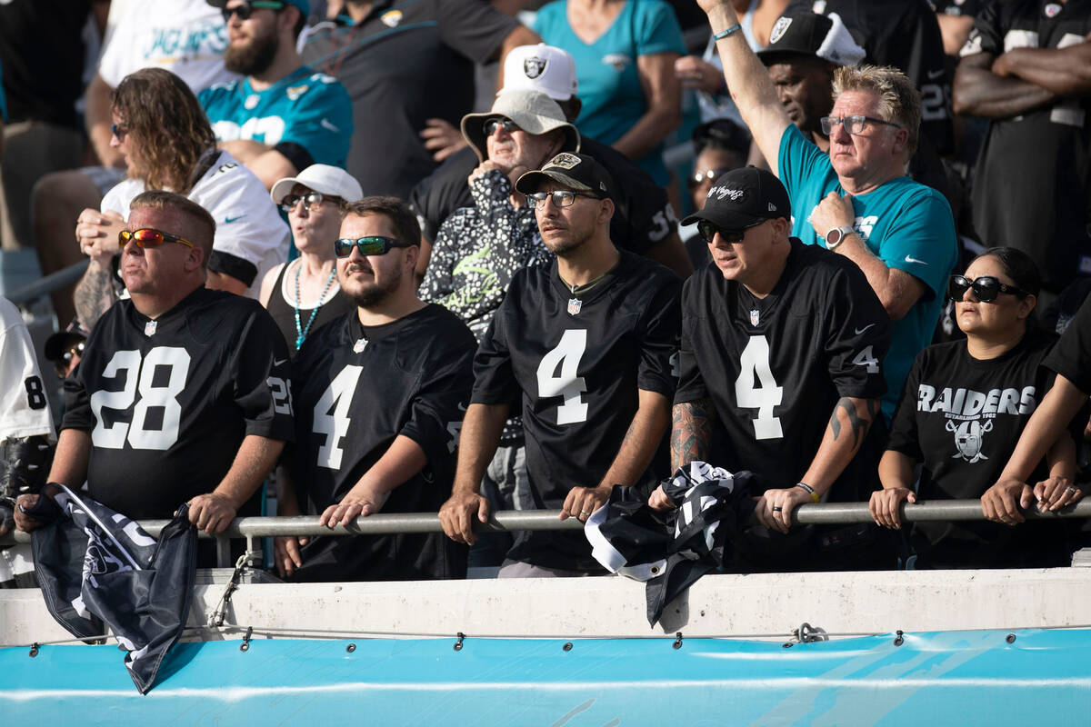 Raiders fans look on after the team failed to convert on a fourth down against the Jacksonville ...