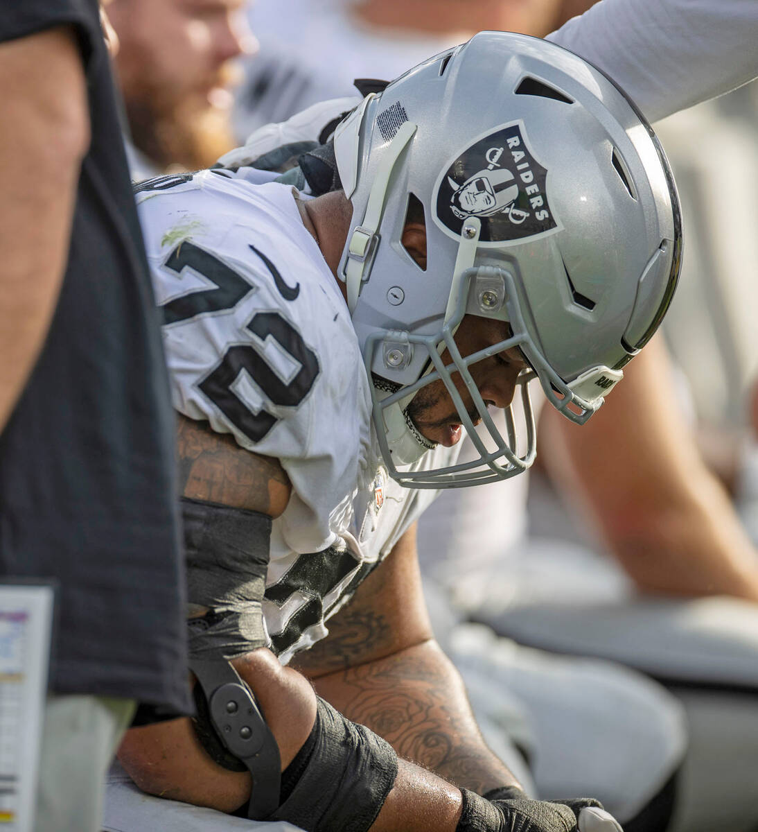 Raiders offensive lineman Jermaine Eluemunor (72) hangs his head down after the offense had a t ...