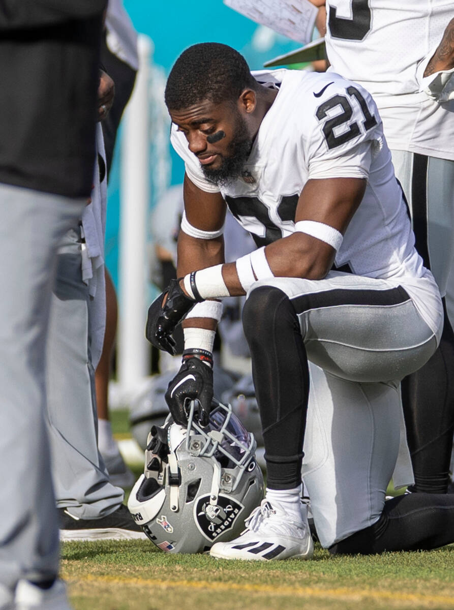 Raiders cornerback Amik Robertson (21) kneels down on the sideline during the second half of an ...