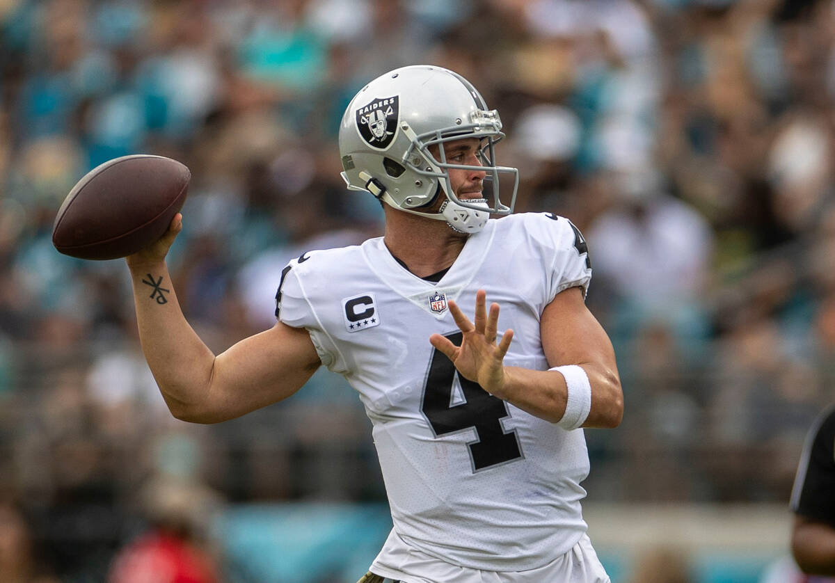 Raiders quarterback Derek Carr (4) makes a throw during the first half of an NFL game against t ...