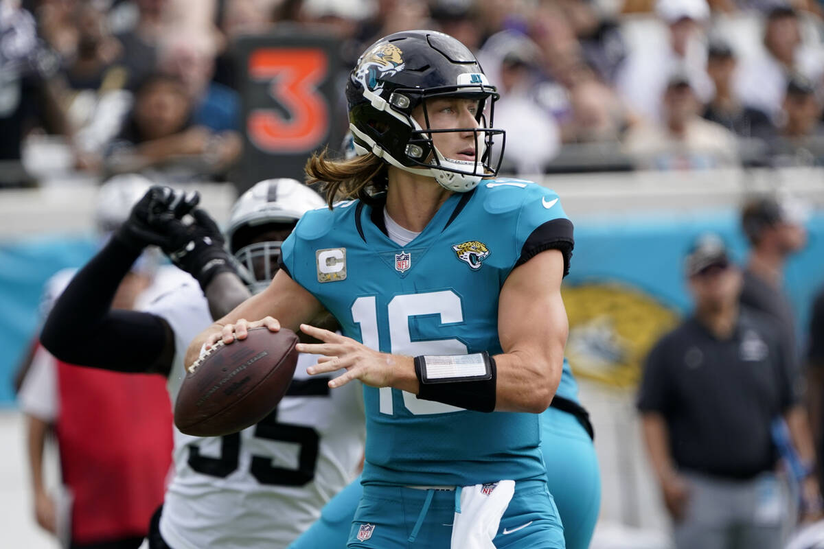 Jacksonville Jaguars quarterback Trevor Lawrence passes against the Las Vegas Raiders in the fi ...