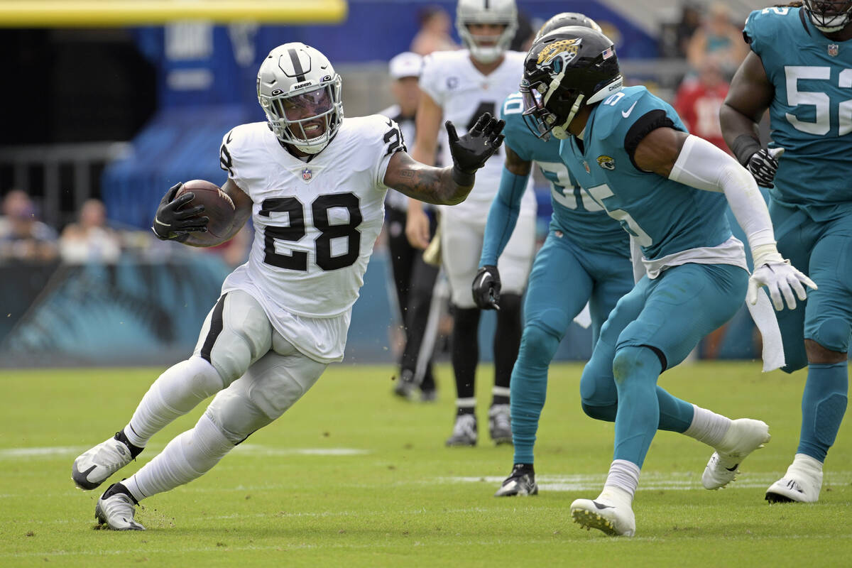 Las Vegas Raiders running back Josh Jacobs (28) tries to get past Jacksonville Jaguars safety A ...