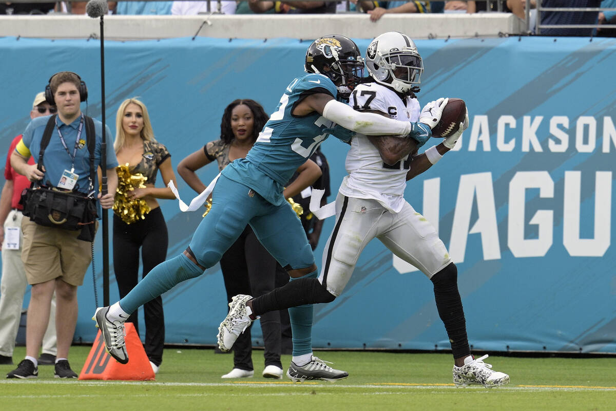 Las Vegas Raiders wide receiver Davante Adams (17) catches a touchdown pass ahead of Jacksonvil ...