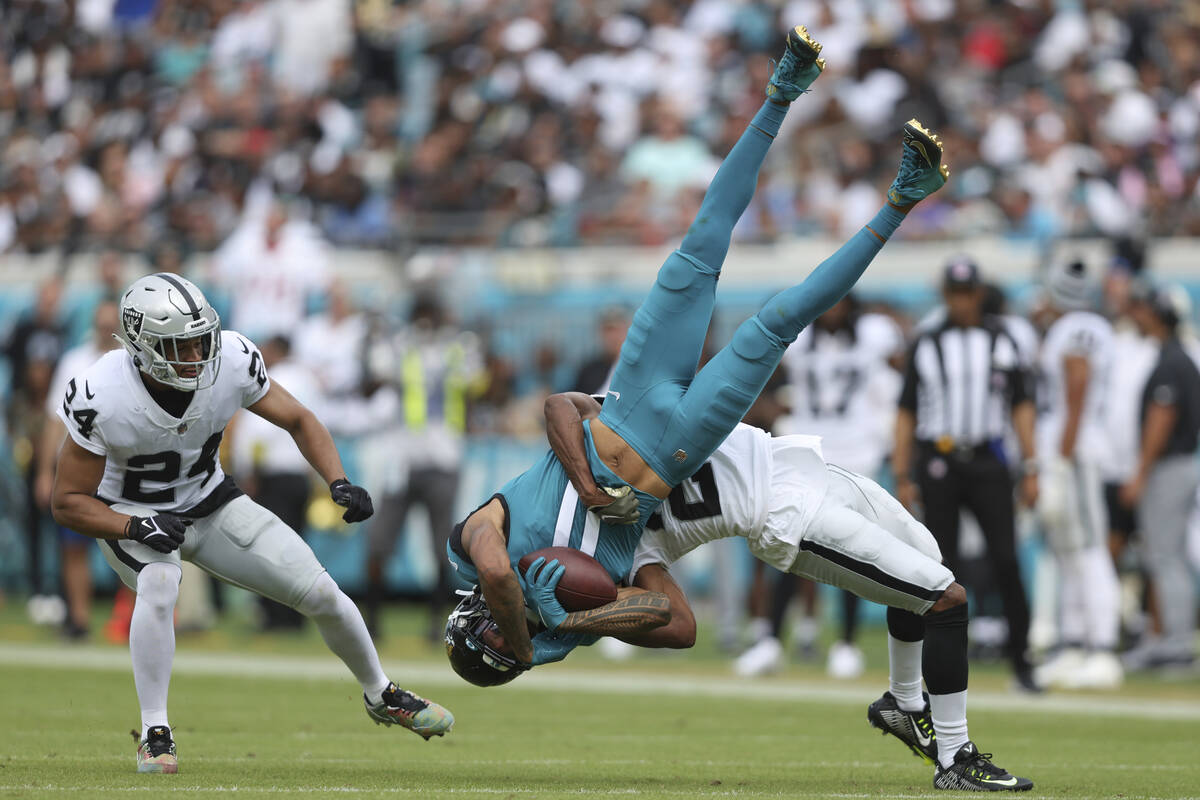 Jacksonville Jaguars wide receiver Marvin Jones Jr. (11) is tackled by catches a pass for a tou ...