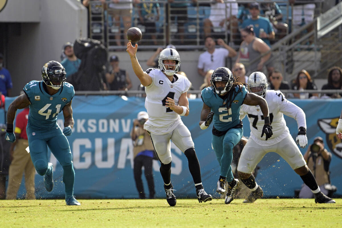 Las Vegas Raiders quarterback Derek Carr (4) passes as he is pressured by Jacksonville Jaguars ...