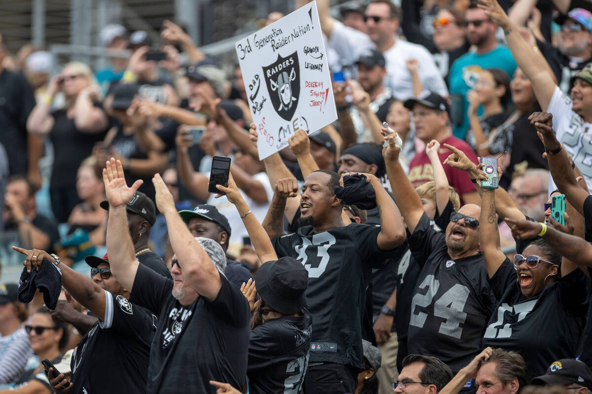 Raiders fans celebrate Raiders wide receiver Davante Adams’ ouchdown score, not pictured ...