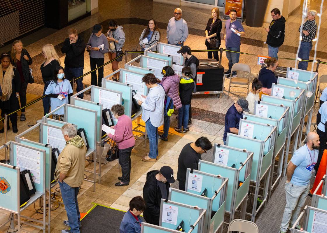 Voters cast their vote as others wait in line to cast their vote at Galleria at Sunset, on Tues ...