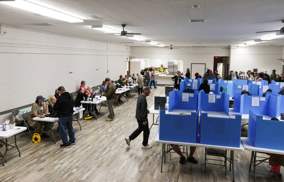 Nye County voters line up and check in with poll workers to cast their ballots on Election Day ...