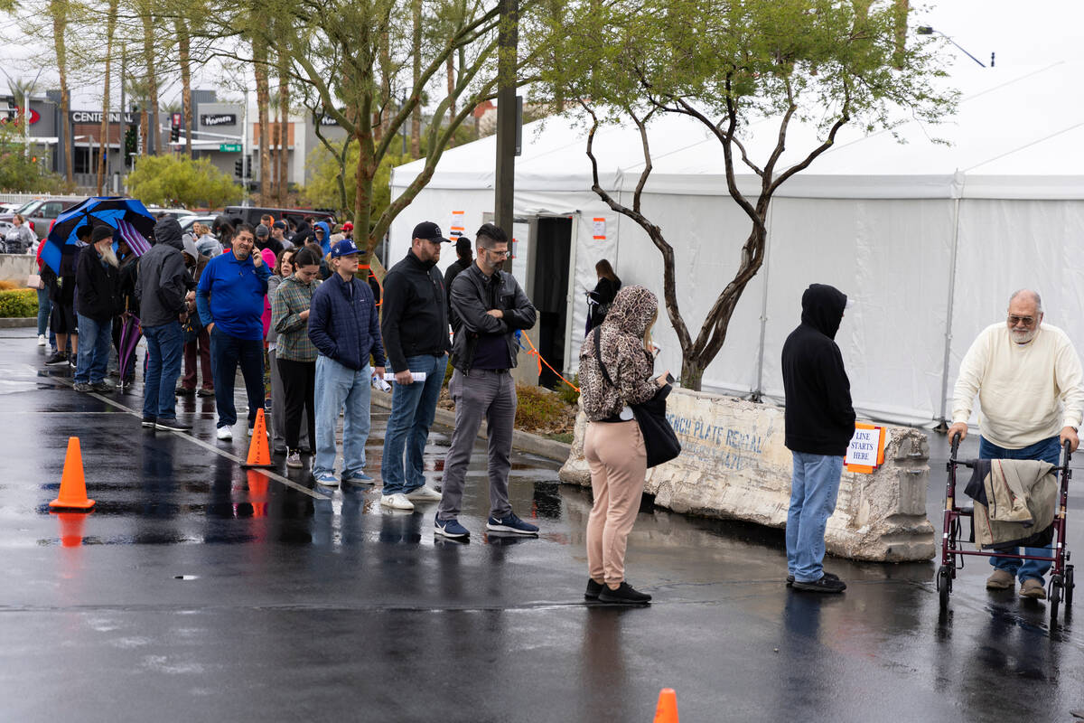 People wait in line to cast their vote at the Centennial Center polling place in Las Vegas, Tue ...