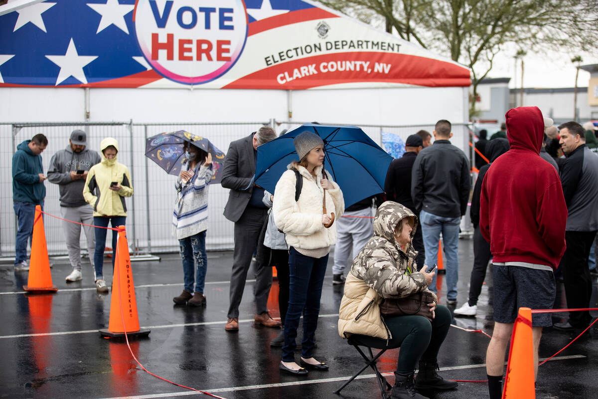 People wait in line to cast their vote at the Centennial Center polling place in Las Vegas, Tue ...