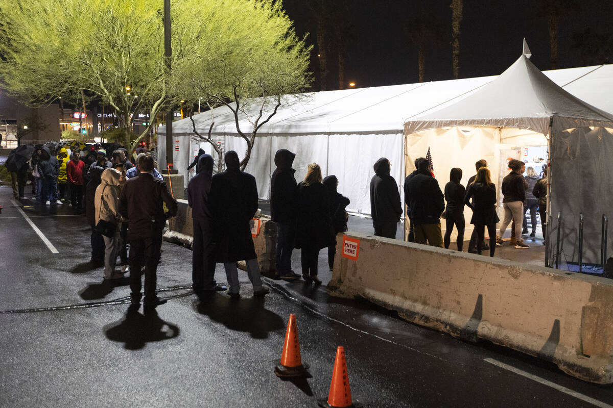 People wait in line to cast their vote at the Centennial Center polling center in Las Vegas, Tu ...