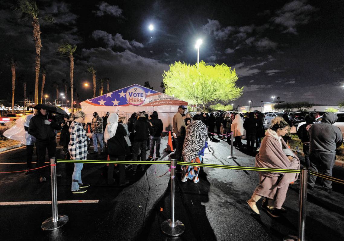 People wait in line to cast their vote at the Centennial Center polling center in Las Vegas, Tu ...