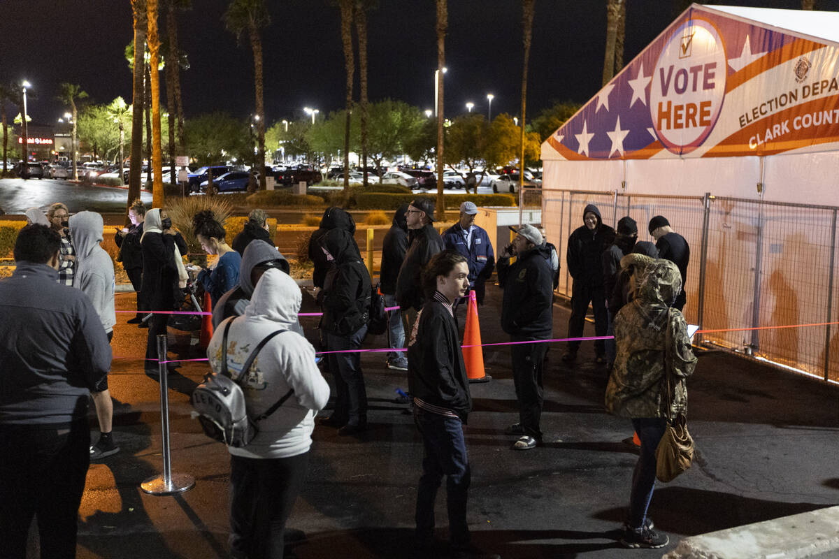 People wait in line to cast their vote at the Centennial Center polling center in Las Vegas, Tu ...
