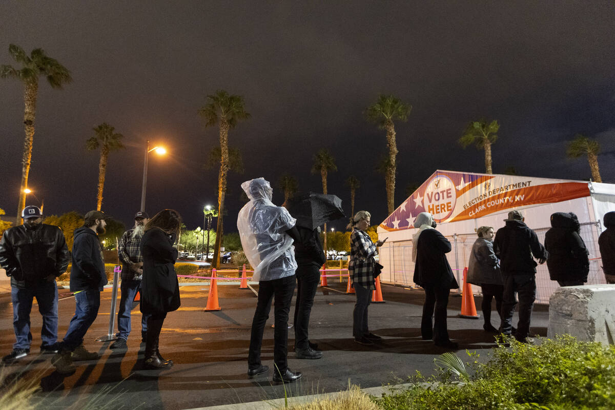 People wait in line to cast their vote at the Centennial Center polling center in Las Vegas, Tu ...