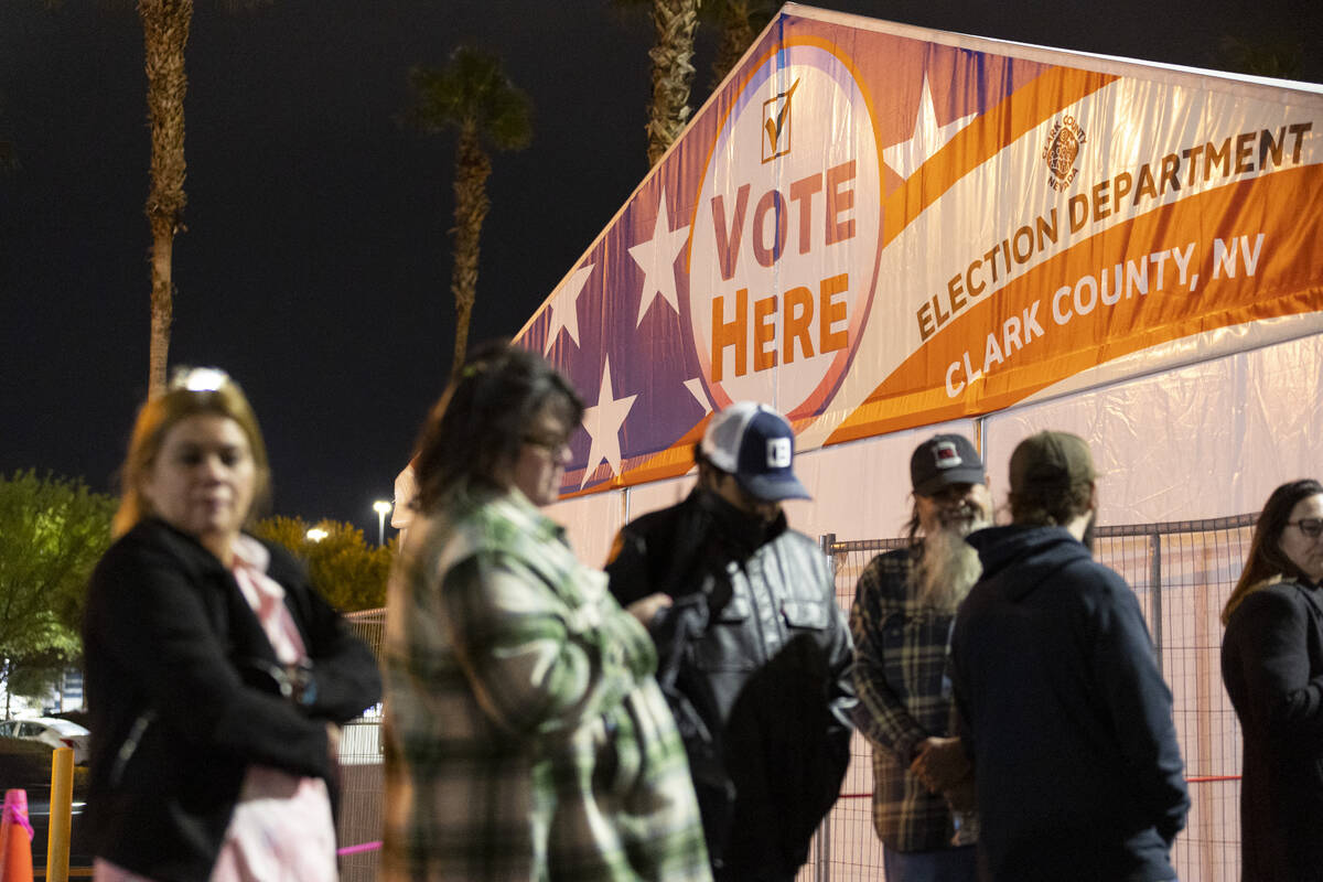 People wait in line to cast their vote at the Centennial Center polling center in Las Vegas, Tu ...
