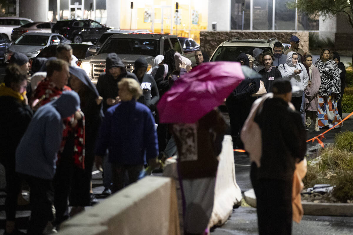 People wait in line to cast their vote at the Centennial Center polling center in Las Vegas, Tu ...