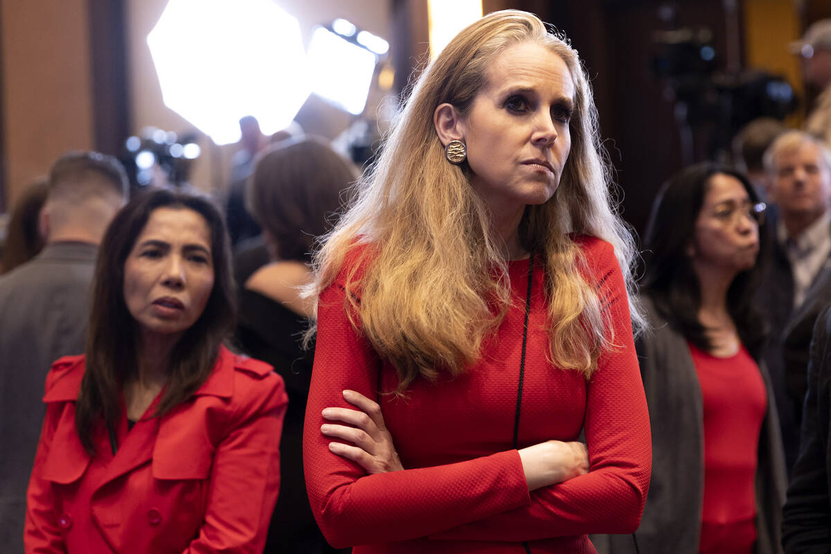 Jennifer McGrath, of Las Vegas, watches election results roll in on television during a GOP mid ...