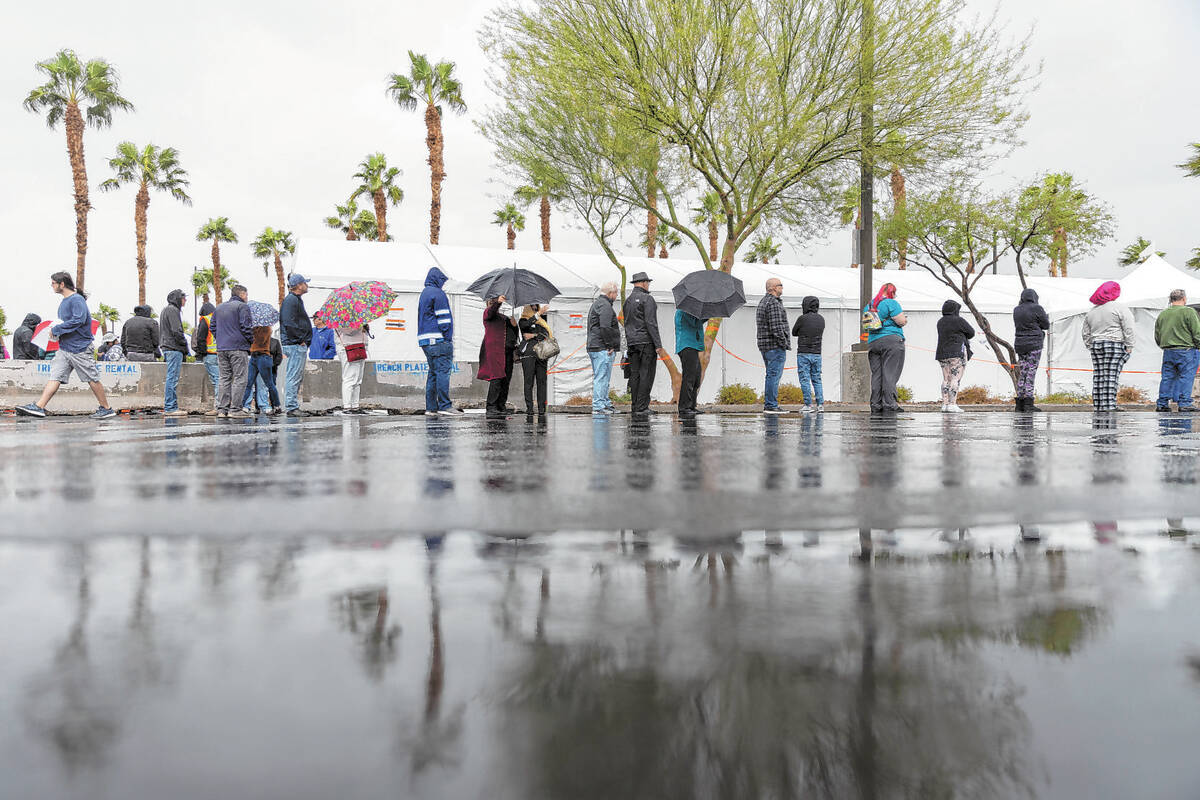 People wait in line to cast their vote at the Centennial Center polling place in Las Vegas, Tue ...