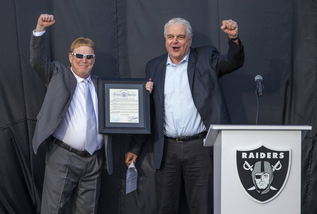Las Vegas Raiders owner Mark Davis, left, cheers the crowd along with Nevada Governor Steve Sis ...