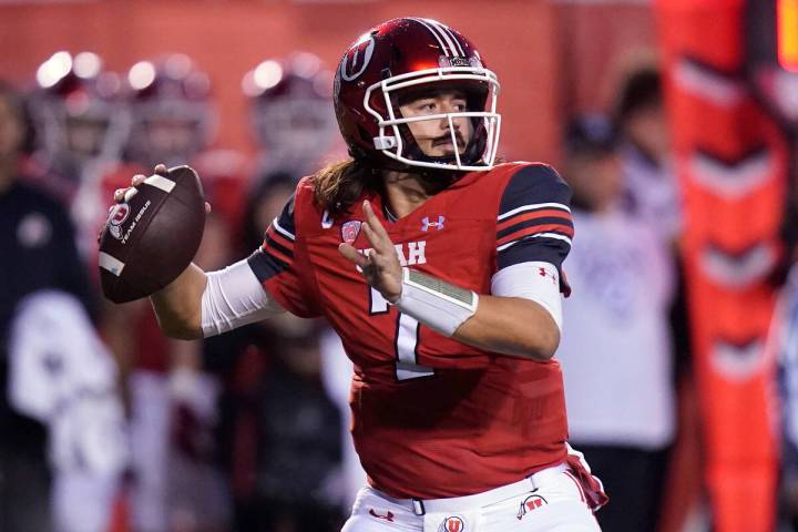 Utah quarterback Cameron Rising throws upfield during the first half of an NCAA college footbal ...