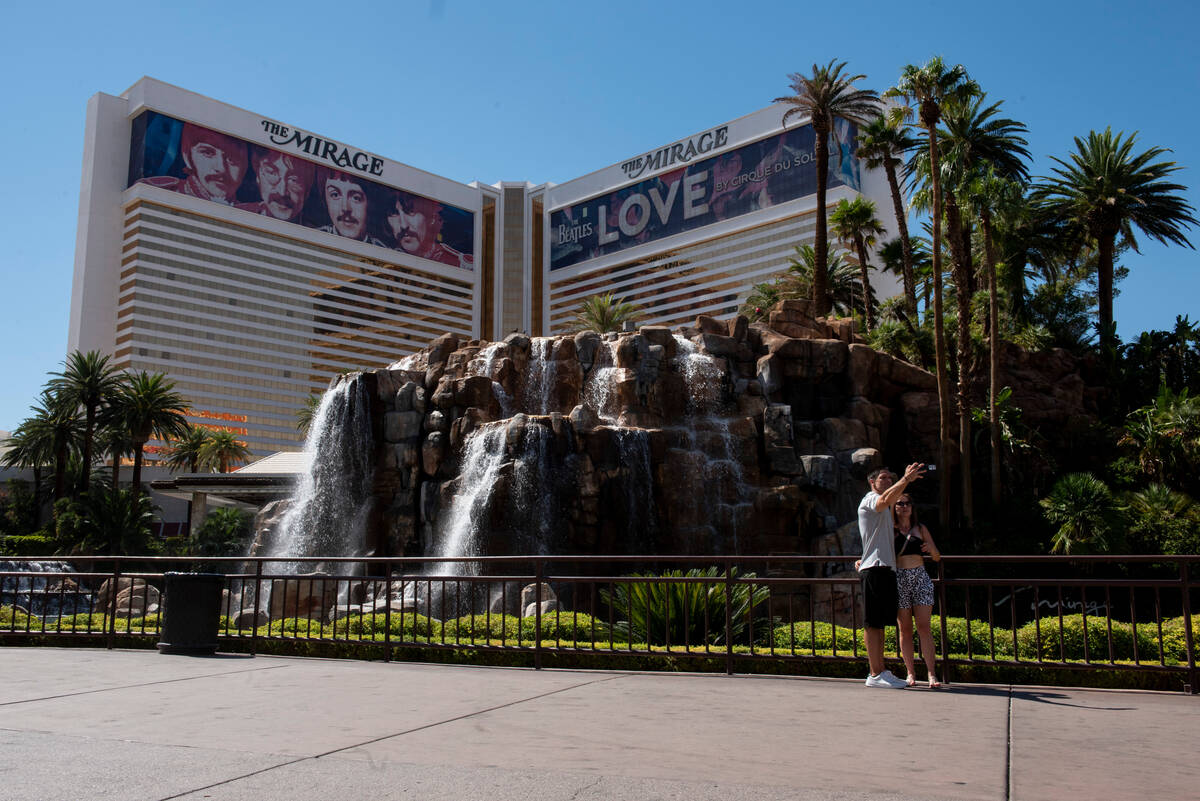 Carlos Burgos, left, and Heidy Rivera, of Puerto Rico, take a selfie in front of The Mirage hot ...
