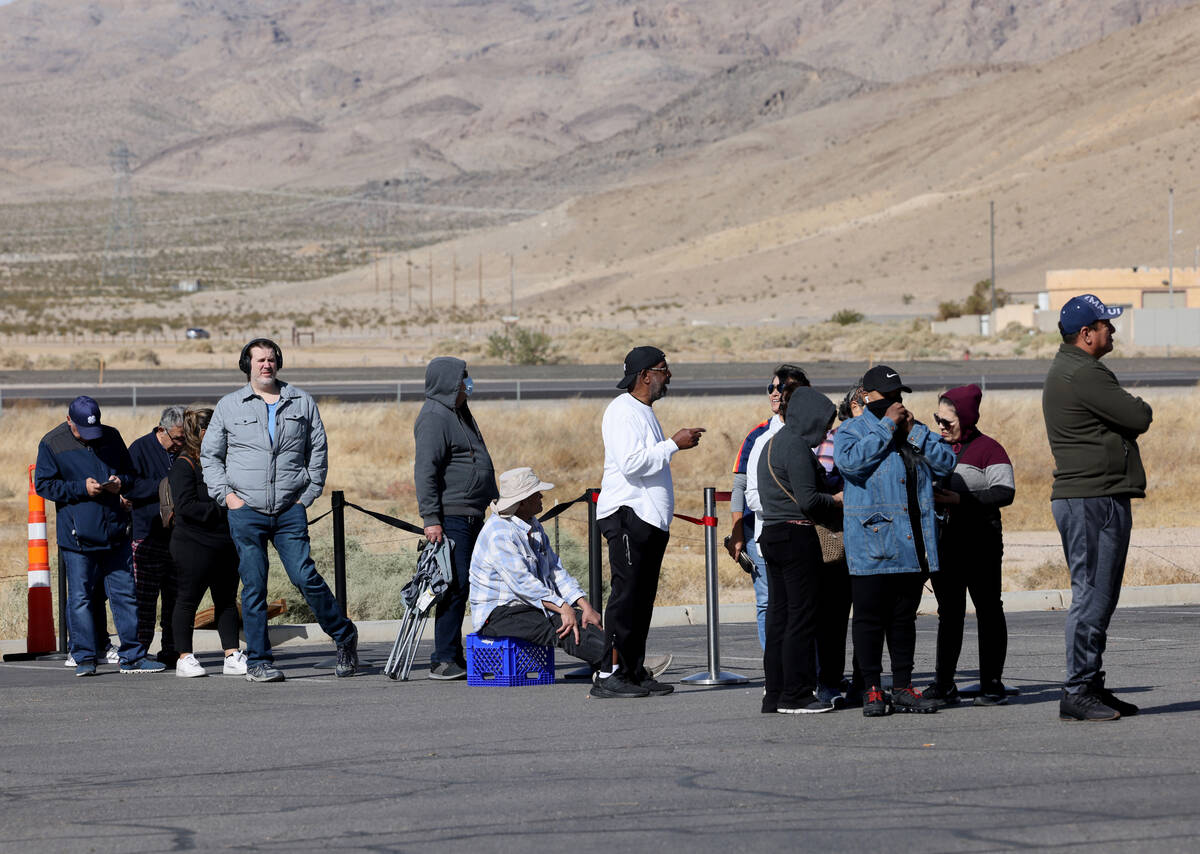 People wait in line to buy lottery tickets at the Lotto Store just across the Nevada/California ...